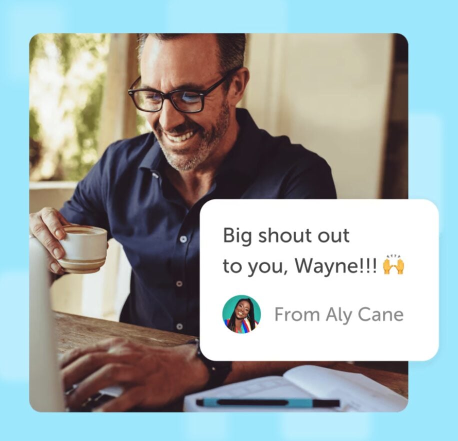 A man with a coffee cup looking at his laptop excitedly because he just received an ecard